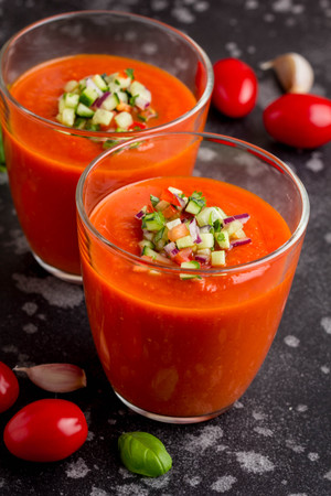 Italian red tomato cold gazpacho soup in glass, with cucumber, onion, Basilの写真素材