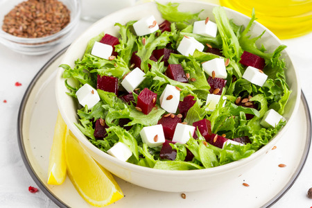 Tasty alad with lettuce, boiled beets, feta cheese, flax seeds and lemonの写真素材