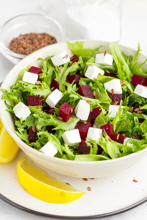 Tasty alad with lettuce, boiled beets, feta cheese, flax seeds and lemonの写真素材