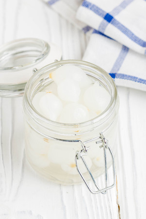 Marinated pearl onion in glass jar, pickled snackの写真素材