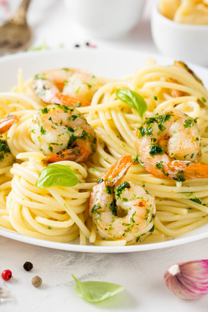 Italian pasta, spaghetti with shrimp, herbs, garlic and cheese. Delicious healthy foodの写真素材