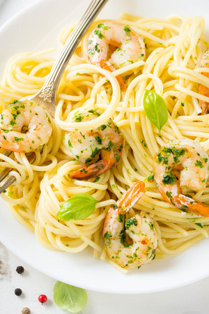 Italian pasta, spaghetti with shrimp, herbs, garlic and cheese. Delicious healthy foodの写真素材