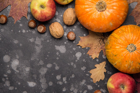 Apples, pumpkins,hazelnut, walnut and fallen leaves on dark background. Copy space for text, top view. Thanksgiving backgroundの写真素材