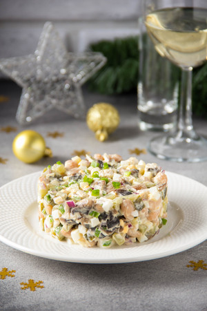 Russian salad with meat, potatoes, egg, cucumber, beans, onion, mushrooms and mayonnaise.の写真素材