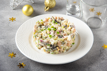 Russian salad with meat, potatoes, egg, cucumber, beans, onion, mushrooms and mayonnaise.の写真素材