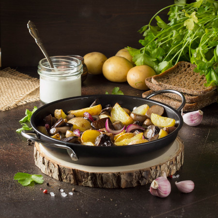 Fried potatoes with forest mushrooms, boletus, onions and sour cream.の写真素材