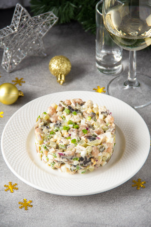 Russian salad with meat, potatoes, egg, cucumber, beans, onion, mushrooms and mayonnaise.の写真素材