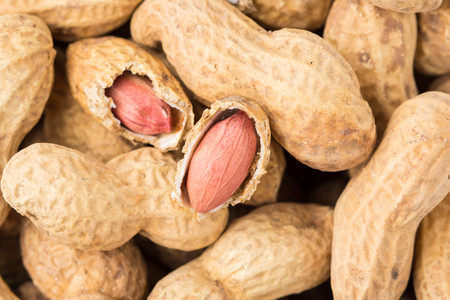 Close up of peanut in shell and peeled. Healthy food, whole untreated nuts, delicious snack
