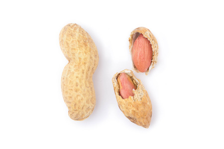 Close up of split peanuts in shell on whiteの写真素材