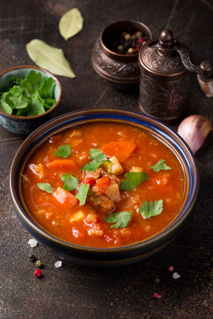Thick tomato soup with meat, cereals and vegetables.の写真素材