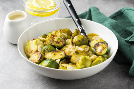 Roasted Brussels sprouts with peanuts and white sauce, delicious vegetarian lunch. Healthy, organic food, vegetable garnishの写真素材