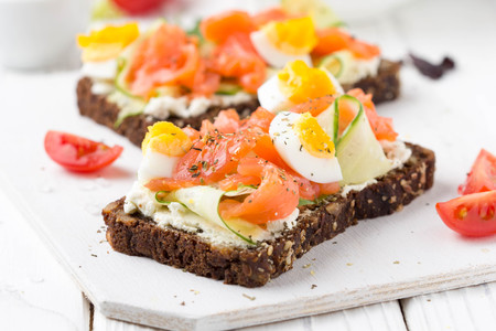 Salmon toast with cream cheese, cucumber and egg. Delicious lunch, healthy food, fish sandwich, diet snackの写真素材