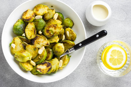 Roasted Brussels sprouts with peanuts and white sauce, delicious vegetarian lunch. Healthy, organic food, vegetable garnishの写真素材