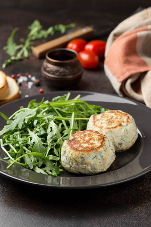 Fried chicken cutlet with herbs, delicious healthy lunch, children's food, diet. Meatballs with salad on dark backgroundの写真素材