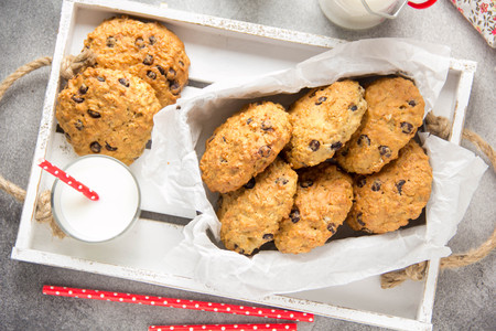 Homemade oatmeal cookies with chocolate and banana, milk in a glass with a tube. Delicious dessert, Breakfast (lunch), healthy food, pastries for childrenの写真素材