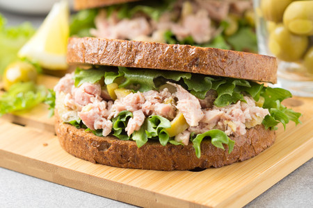 Sandwich with tuna, olives and lemon. Delicious lunch, healthy food, snack with fish on crispy toastの写真素材