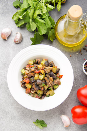 Vegetable stew with eggplant, zucchini, tomatoes, onions, mushrooms, garlic and cilantro. Vegetarian ajapsandali, Italian caponata. Traditional saute Ratatouilleの写真素材