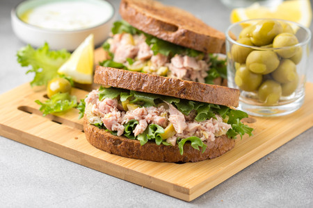 Sandwich with tuna, olives and lemon. Delicious lunch, healthy food, snack with fish on crispy toastの写真素材