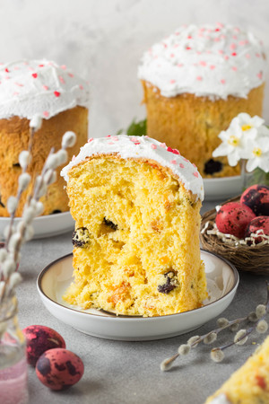 Easter cakes with icing and pink sprinkles, dried fruits and candied fruits, painted quail eggs,...