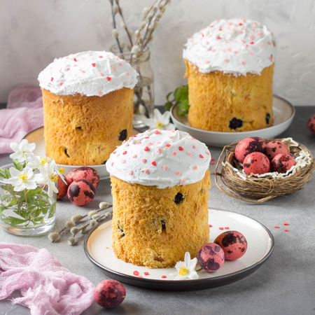 Easter cakes with icing and pink sprinkles, dried fruits and candied fruits, painted quail eggs, spring holidayの写真素材