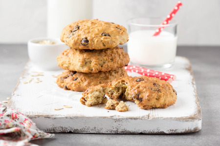 Homemade oatmeal cookies with chocolate and banana, milk in a glass with a tube. Delicious dessert, Breakfast (lunch), healthy food, pastries for childrenの写真素材