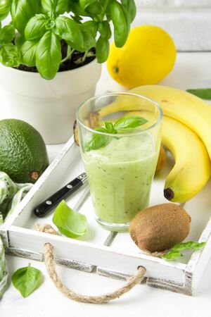 Green smoothie with banana, kiwi, Basil and avocado. Delicious healthy drink, summer snack, fresh tasteの写真素材