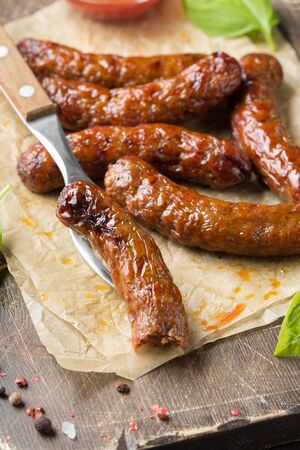 Grilled sausages with meat (beef, pork, lamb) and spices, hot merguez, kabanos, chorizo. Delicious fried food for a picnicの写真素材