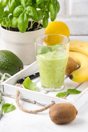 Green smoothie with banana, kiwi, Basil and avocado. Delicious healthy drink, summer snack, fresh tasteの写真素材