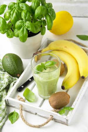 Green smoothie with banana, kiwi, Basil and avocado. Delicious healthy drink, summer snack, fresh tasteの写真素材
