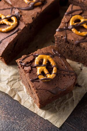 Chocolate brownie on dark beer with salted pretzels and chocolate. Delicious brutal dessert for men, sweet foodの写真素材