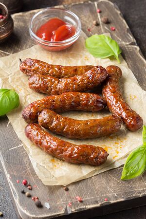 Grilled sausages with meat (beef, pork, lamb) and spices, hot merguez, kabanos, chorizo. Delicious fried food for a picnicの写真素材
