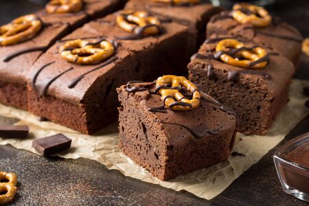 Chocolate brownie on dark beer with salted pretzels and chocolate. Delicious brutal dessert for men, sweet foodの写真素材