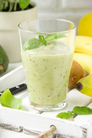 Green smoothie with banana, kiwi, Basil and avocado. Delicious healthy drink, summer snack, fresh tasteの写真素材