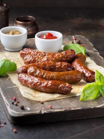 Grilled sausages with meat (beef, pork, lamb) and spices, hot merguez, kabanos, chorizo. Delicious fried food for a picnicの写真素材