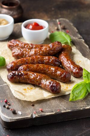 Grilled sausages with meat (beef, pork, lamb) and spices, hot merguez, kabanos, chorizo. Delicious fried food for a picnicの写真素材