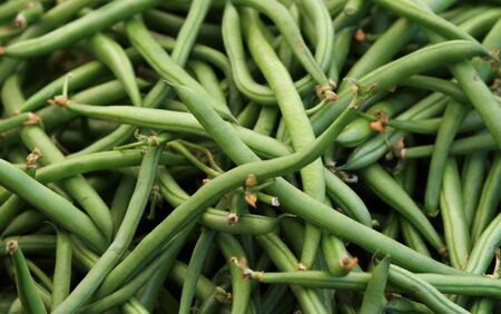 Closeup of green beans on the market stall. Intense green color