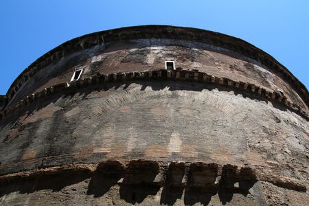 Side of the walls of the Pantheon in Rome. Cylindrical shape, brick construction. Blue sky in the background.の写真素材