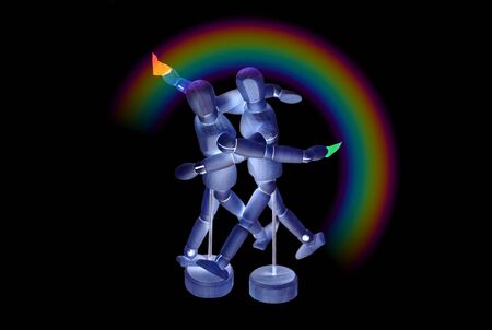 Two mannequins who have freed themselves from the mask embrace and dance. Invert colors effect. Black background with rainbow.の写真素材