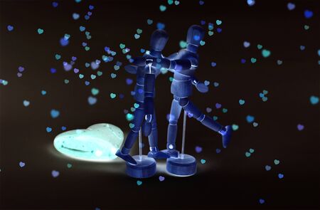 Pair of dummies, dance. In the background, a large heart and rain of colorful hearts. Invert colors effect, dark background.の写真素材