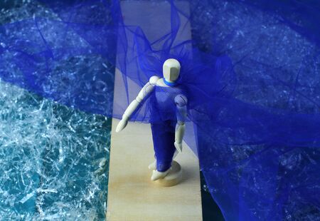 Mannequin from above with blue toulle dress walking along a catwalk.