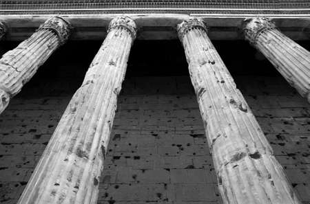 Temple of Hadrian, Piazza di Pietra in Rome. Detail of the ancient marble columns. Low angle view.