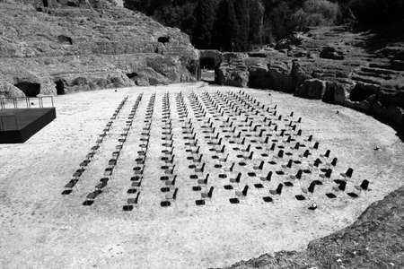 Top view of a series of chairs in a row inside the Roman amphitheater of Sutri (Viterbo, Italy)...