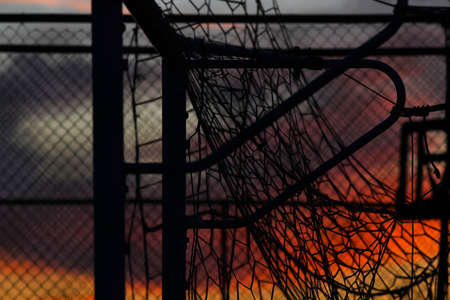 Backlight of tangle of nets, in the background sky reddened by the light of the sunset.