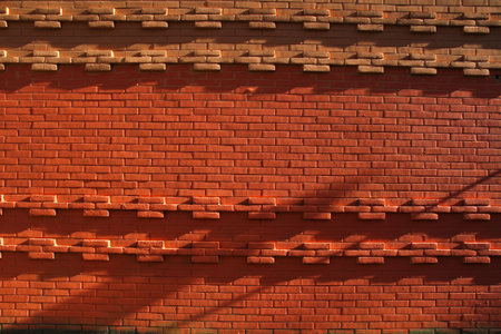 Red brick wall exposed to bright daylight.の写真素材