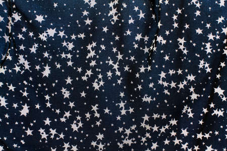 Tulle fabric with designs of white stars on a blue backgroundの写真素材