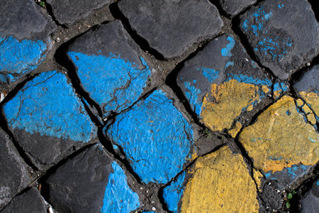 Detail of a Roman road made with large leucitite stones, yellow and blue stripes to delimit the car parking area.の写真素材