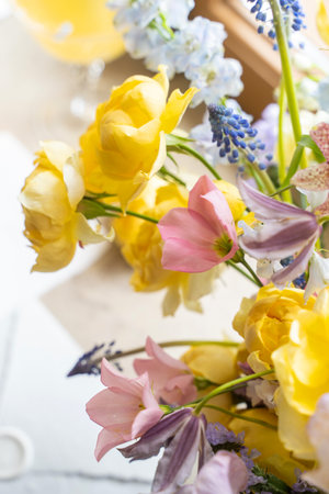 Original wedding floral decoration bouquets of flowers over white invitation. Top view. Vertical. Selective soft focus. Copy space, negative space for design advertisementの写真素材