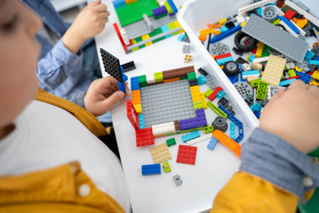 Robotics programming class. Children construct and code Robot. STEM education using constructor blocks and laptop, remote control joystick. Technology educational development for school kids. Advertisement copy spaceの写真素材