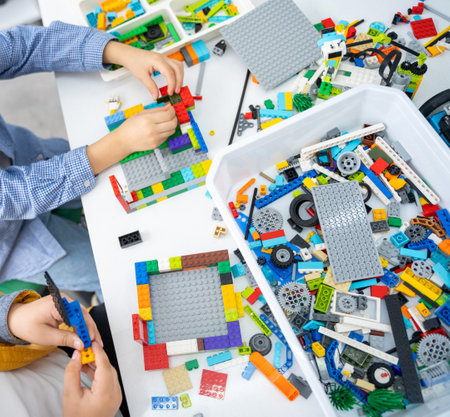 Robotics programming class. Children construct and code Robot. STEM education using constructor blocks and laptop, remote control joystick. Technology educational development for school kids. Advertisement copy spaceの写真素材