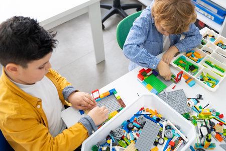 Robotics programming class. Children construct and code Robot. STEM education using constructor blocks and laptop, remote control joystick. Technology educational development for school kids. Advertisement copy spaceの写真素材